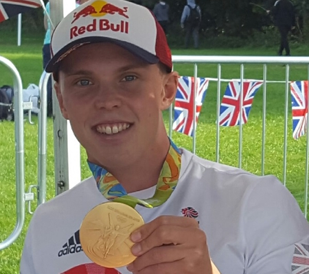 Olympic Canoeist Joe Clarke holding gold medal