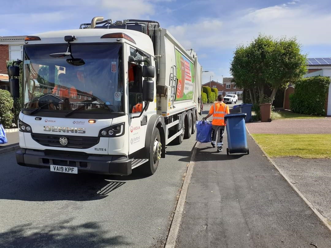 Bin lorry and bins being collected