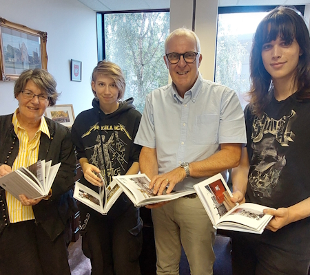 Students with Council Leader showing their books