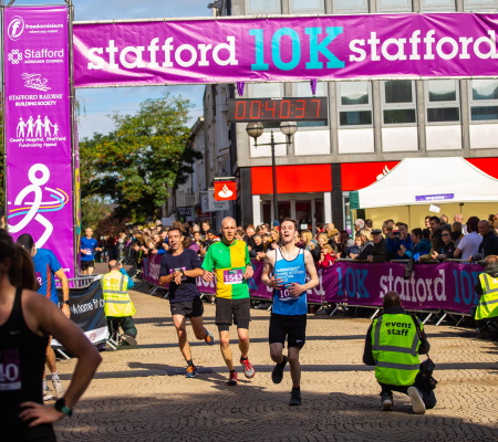 Runners crossing the finishing line in the Stafford 10k